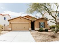 Charming single-story home with a two-car garage, stucco exterior, and well-maintained front yard at 25640 N 108Th Dr, Peoria, AZ 85383