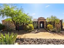 Charming stone and stucco home with beautiful desert landscaping and stone archway entrance at 28025 N 156Th Pl, Scottsdale, AZ 85262