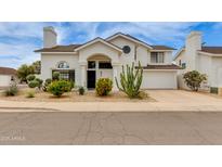 Charming home featuring an arched entryway, desert landscaping, and attached two car garage at 3315 E Taro Ln, Phoenix, AZ 85050