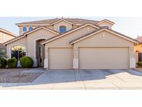 Spacious, two-story home featuring a three-car garage and manicured landscaping at 43615 W Roth Rd, Maricopa, AZ 85138