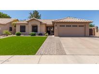 Charming single-story home featuring a well-manicured lawn and a two-car garage at 6357 W Potter Dr, Glendale, AZ 85308