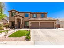 Inviting two-story home featuring a well-maintained lawn and a spacious two-car garage at 7385 W Honeysuckle Dr, Peoria, AZ 85383