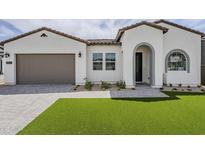 Beautiful white single-story home with well-maintained landscaping and a brown two-car garage at 11045 N Hershey St, Surprise, AZ 85388