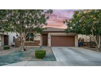 Charming single-story home with a two-car garage, desert landscaping and cozy curb appeal at 11742 W Chase Ln, Avondale, AZ 85323