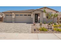 Charming home with a two-car garage, stone accents, and manicured landscaping at 12381 W Marguerite Ave, Avondale, AZ 85323