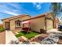 Charming home featuring a cozy front yard with a swing for relaxing at 12606 W Scotts Dr, El Mirage, AZ 85335