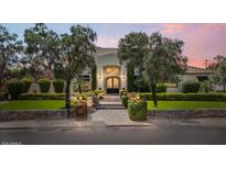 Stunning home showcasing mature trees, manicured landscaping, and a stone pathway leading to the front entrance at 13250 N 13Th Ln, Phoenix, AZ 85029