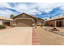 Cozy single-story home featuring a two-car garage and drought-resistant landscaping at 15980 W Smokey Dr, Surprise, AZ 85374