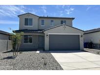 Charming two-story home with a two-car garage, a well-manicured lawn, and inviting curb appeal at 17245 W Corrine Dr, Surprise, AZ 85388