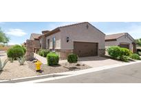 Charming single-Gathering home featuring desert landscaping, stone accents, and a two-car garage at 1847 N Red Clf, Mesa, AZ 85207