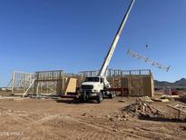 Framing underway at a new home construction site under a clear blue sky at 1904 E Creek Canyon Rd, Phoenix, AZ 85086