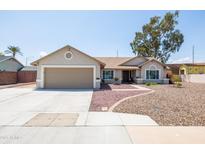 Charming single-story home featuring a well-manicured front yard and a neutral-colored exterior, including a two-car garage at 3605 W Pecos Rd, Chandler, AZ 85226
