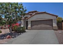 Charming single-story home featuring a two-car garage, neutral stucco, and desert landscaping, adding to its curb appeal at 3812 W Carlos Ln, San Tan Valley, AZ 85144