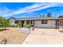 Charming single story home featuring beautiful landscaping and a spacious front yard, with a large driveway at 4028 W El Camino Dr, Phoenix, AZ 85051