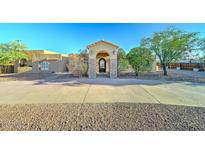 Stunning single-story home with a grand entrance, mature trees, and a circular driveway at 6519 E Cactus Rd, Scottsdale, AZ 85254