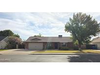 Charming single-story brick home featuring a two-car garage and mature landscaping at 664 N Glenview --, Mesa, AZ 85213