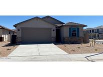 Charming single-story home with a stone-accented facade, a two-car garage and a well-kept desert landscape at 7229 E Cattle Call St, San Tan Valley, AZ 85143