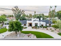 Stunning modern home with unique landscaping and a circular driveway, showcasing its curb appeal at 8230 E Wood Dr, Scottsdale, AZ 85260