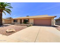Single Gathering home showing the front yard, driveway, garage, and some stonework at 863 Leisure World --, Mesa, AZ 85206