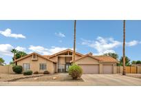 Charming single-story home featuring a terracotta roof, desert landscaping, and a spacious two-car garage at 8913 S Forest Ave, Tempe, AZ 85284