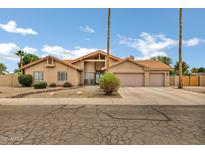 Charming single-story home featuring a neutral color palette, tile roof, manicured landscaping, and a spacious two-car garage at 8913 S Forest Ave, Tempe, AZ 85284