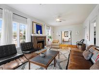 Cozy living room featuring hardwood floors, a fireplace, and ample seating for Gathering and guests at 905 E Coronado Rd, Phoenix, AZ 85006