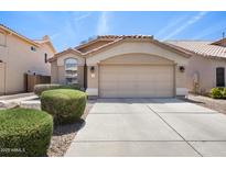 Charming home featuring a two-car garage, well-maintained landscaping, and a tiled roof at 93 S Sandstone St, Gilbert, AZ 85296