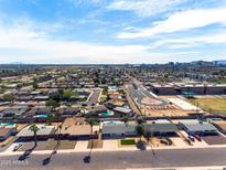 Expansive aerial view of a neighborhood with mature trees and clear blue skies at 1209 E Marigold Ln, Tempe, AZ 85288