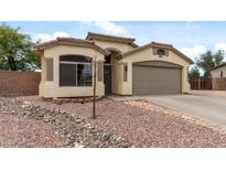 Charming single-story home with a two-car garage and well-maintained front yard with desert landscaping at 13438 N 130Th Ln, El Mirage, AZ 85335
