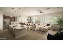Open-concept living area with stainless steel appliances, an island kitchen, and a comfortable sofa at 1529 W State Ave, Phoenix, AZ 85021
