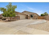 Charming single-story home featuring stone accents, a well-manicured lawn, and a welcoming facade at 17292 W Pinnacle Vista Dr, Surprise, AZ 85387