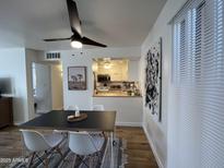 Bright dining area featuring a modern table, stylish chairs, and an open view to the kitchen at 1823 E Kirkland Ln # C, Tempe, AZ 85281
