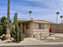 Charming mobile home with well-maintained landscaping and covered parking on a beautiful day at 318 S Crismon Rd # 65, Mesa, AZ 85208