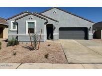 Charming single-story home with a gray exterior, desert landscaping, and an attached two-car garage at 38150 W Bello Ln, Maricopa, AZ 85138