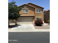 Two-story home featuring an attached two-car garage and low maintenance landscaping at 40246 W Hopper Dr, Maricopa, AZ 85138