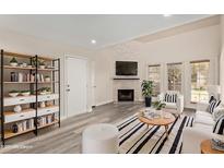 Bright living room features a decorative fireplace, modern furnishings, and ample natural light at 4901 S Calle Los Cerros Dr # 220, Tempe, AZ 85282