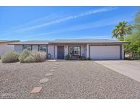 Charming single-story home with low-maintenance landscaping and attached two-car garage at 5133 E Keresan St, Phoenix, AZ 85044