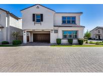Inviting two-story home with a garage, attractive landscaping, and a paved driveway at 651 N Bay Dr, Gilbert, AZ 85233