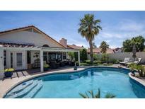 Inviting backyard pool and patio area, perfect for entertaining, with a covered patio and manicured landscaping at 6732 W Sack Dr, Glendale, AZ 85308