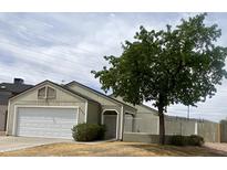 Charming single-story home with a well-maintained front yard and a white garage door at 7026 S 40Th Pl, Phoenix, AZ 85042