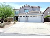 Two-story home featuring a three-car garage, neutral stucco, and drought-resistant landscaping at 733 E Megan Dr, San Tan Valley, AZ 85140