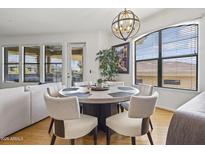 Bright dining room with modern chandelier, large windows, and seating for six at 7601 E Indian Bend Rd # 3030, Scottsdale, AZ 85250