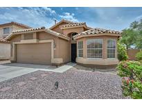 Delightful single-Gathering home showcases a two-car garage, xeriscaping, and a charming window, all contributing to a warm, welcoming feel at 7949 W Wescott Dr, Glendale, AZ 85308