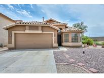 Charming single-Gathering home featuring a two-car garage, gravel landscaping, and a quaint bay window, creating an inviting curb appeal at 7949 W Wescott Dr, Glendale, AZ 85308