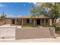 Charming single-story home featuring a low-walled, gated front yard and covered parking at 8542 N 30Th Dr, Phoenix, AZ 85051