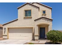Charming two-story home featuring a well-maintained front yard and a two car garage at 8577 S 253Rd Dr, Buckeye, AZ 85326
