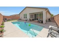 Relaxing backyard pool with patio and outdoor seating offers a perfect retreat at 8683 S 165Th Ave, Goodyear, AZ 85338