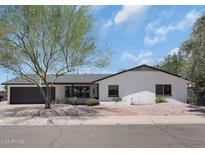 Charming single-story home with a well-maintained yard and mature landscaping in a quiet neighborhood at 8732 E Sandalwood Dr, Scottsdale, AZ 85250