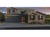 Charming two-story home with a two-car garage and desert landscaping at 10205 W Weldon Ave, Avondale, AZ 85392
