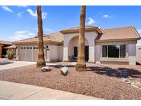 Charming single-story home featuring a tile roof, arched entryway, desert landscaping, and an attached two-car garage at 1320 E Scott Ave, Gilbert, AZ 85234
